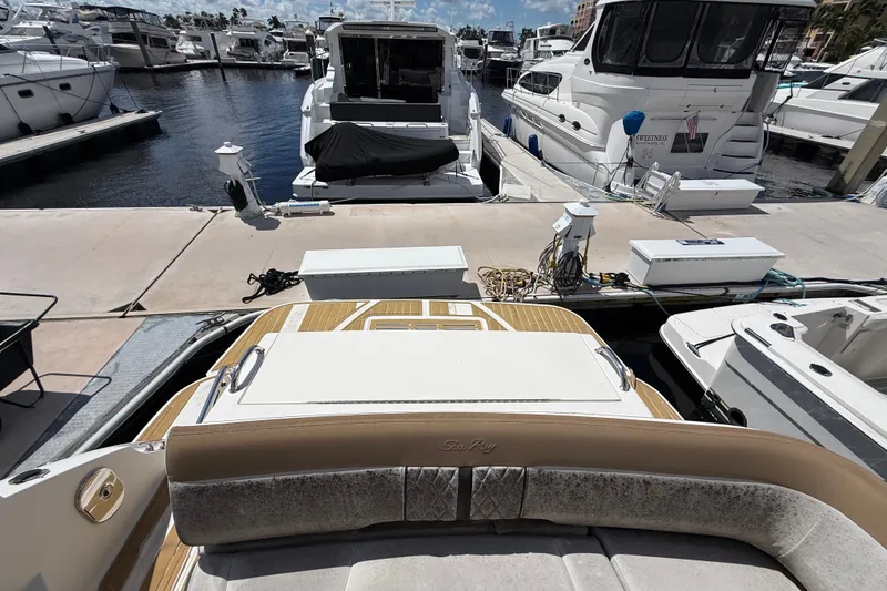 Slide: The Image of 2018 Sea Ray Sundancer 350 Coupe docked at marina, surrounded by other boats. - 94