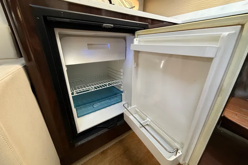 Slide: The Image of Open refrigerator inside 2018 Sea Ray Sundancer 350 Coupe yacht cabin. - 38