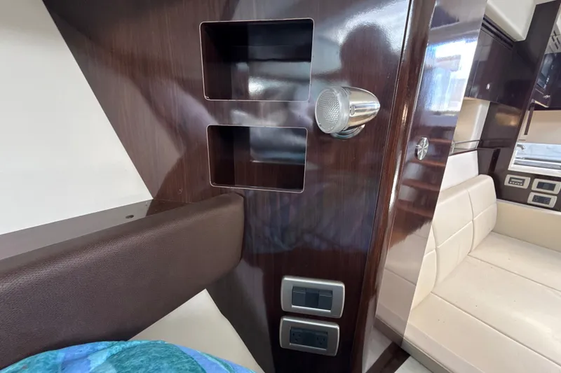 Slide: The Image of Interior of 2018 Sea Ray Sundancer 350 Coupe with wood paneling and seating. - 54