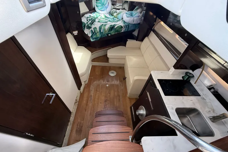Slide: The Image of Interior of 2018 Sea Ray Sundancer 350 Coupe with modern kitchen and cozy seating area. - 32