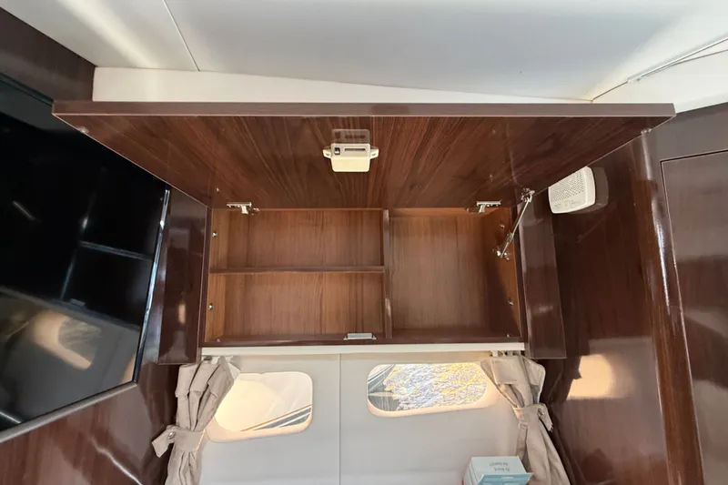 Slide: The Image of Interior cabinet of 2018 Sea Ray Sundancer 350 Coupe with open wooden shelves. - 50