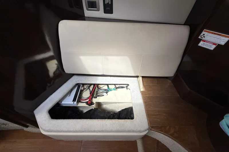Slide: The Image of 2018 Sea Ray Sundancer 350 Coupe interior storage compartment with electrical components. - 51