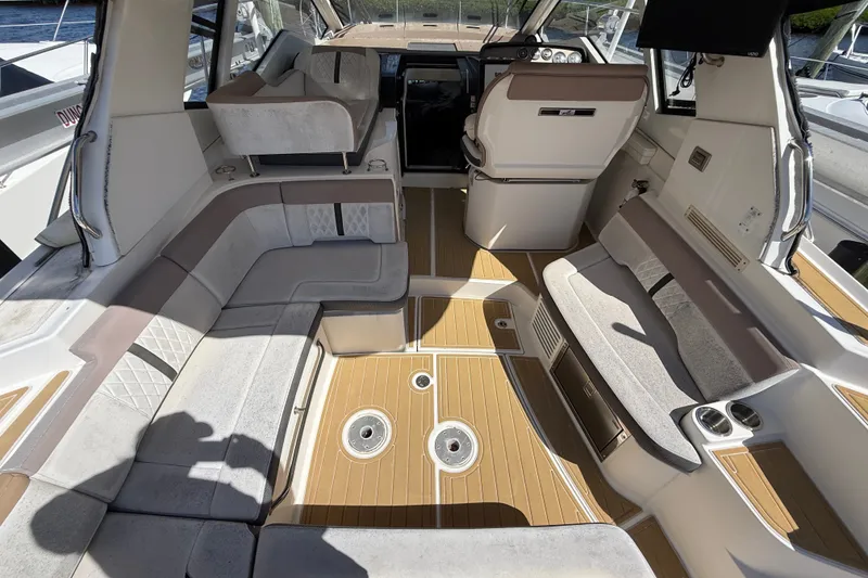 Slide: The Image of 2018 Sea Ray Sundancer 350 Coupe interior with plush seating and modern helm. - 18