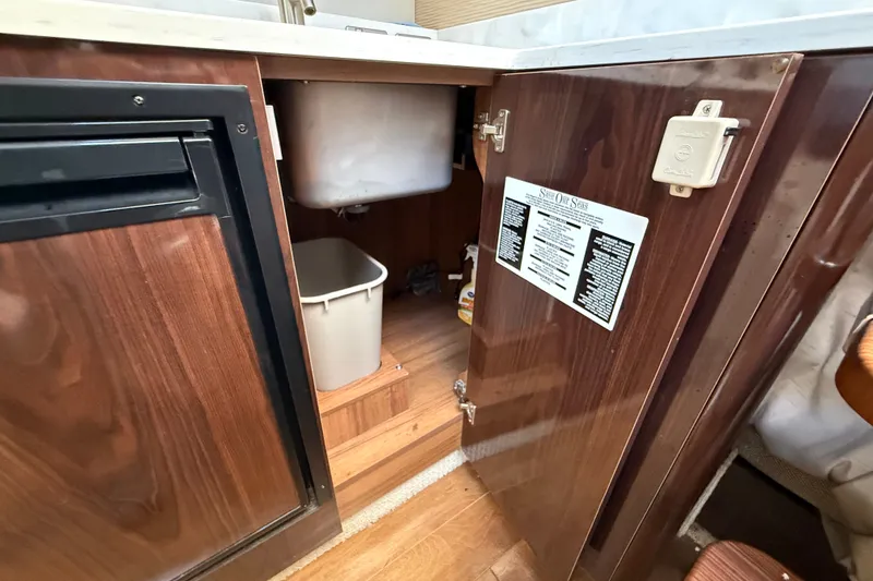 Slide: The Image of Interior view of 2018 Sea Ray Sundancer 350 Coupe kitchen cabinet with open door. - 39