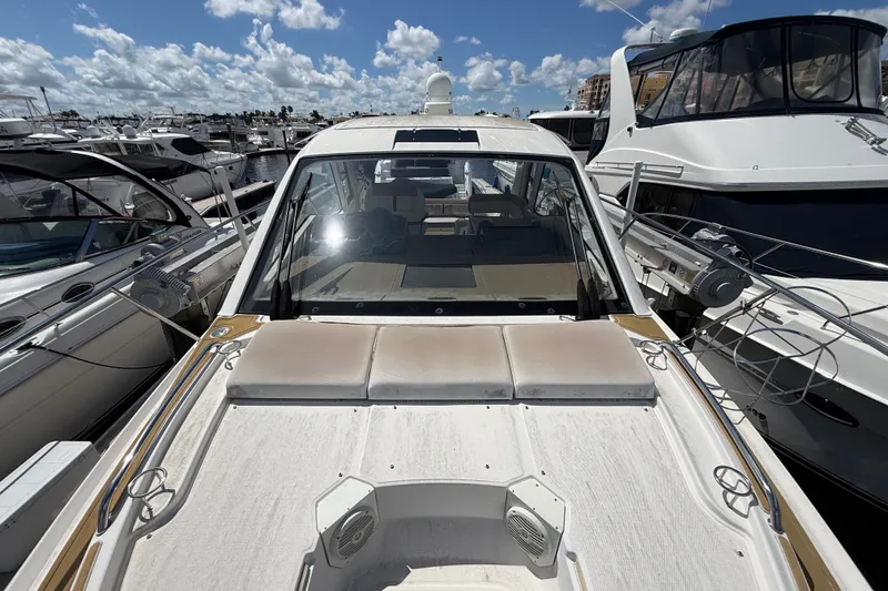 Slide: The Image of 2018 Sea Ray Sundancer 350 Coupe docked at marina under blue sky. - 112