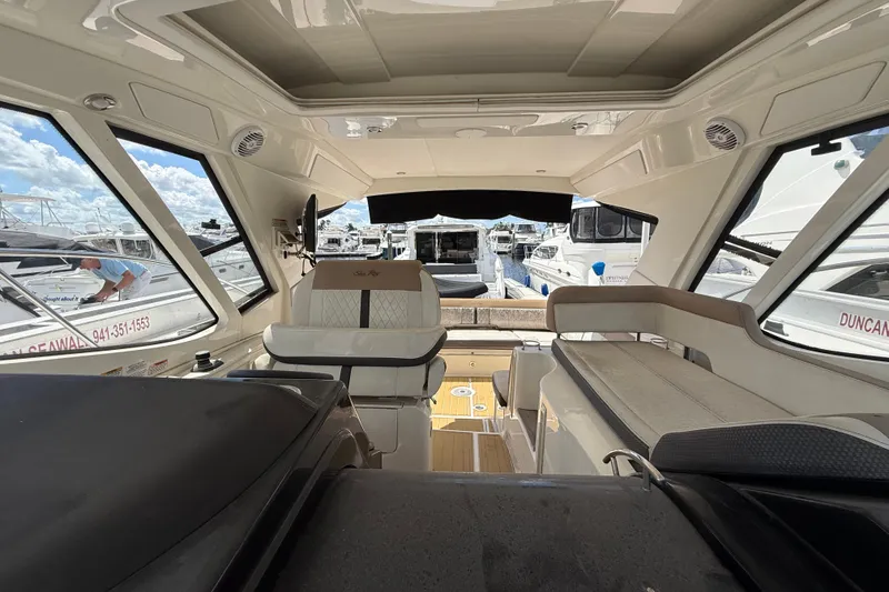 Slide: The Image of Interior view of 2018 Sea Ray Sundancer 350 Coupe yacht, showcasing seating and helm area. - 71