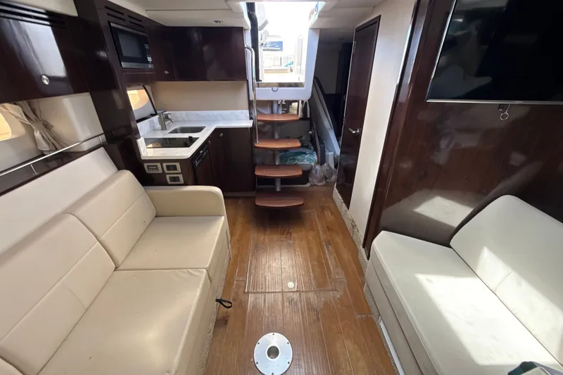 Slide: The Image of Interior of 2018 Sea Ray Sundancer 350 Coupe with modern kitchen and seating area. - 58