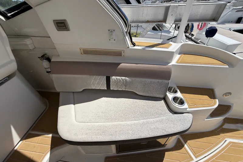 Slide: The Image of Interior seating of 2018 Sea Ray Sundancer 350 Coupe with cup holders and modern design. - 89