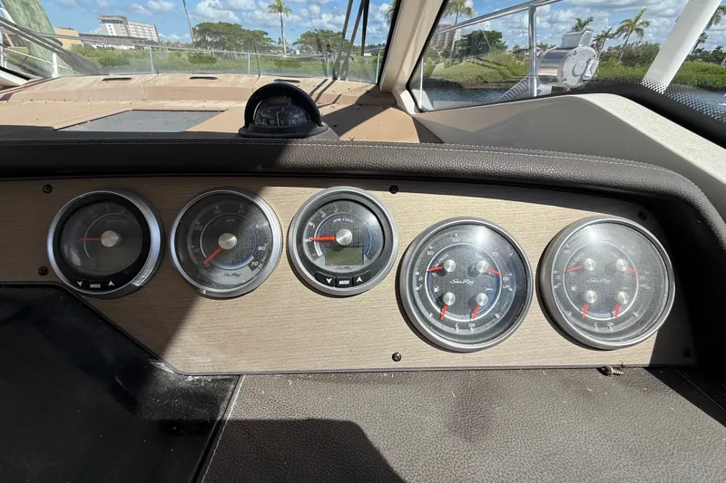 Slide: The Image of Dashboard of a 2018 Sea Ray Sundancer 350 Coupe with multiple gauges and scenic view. - 28