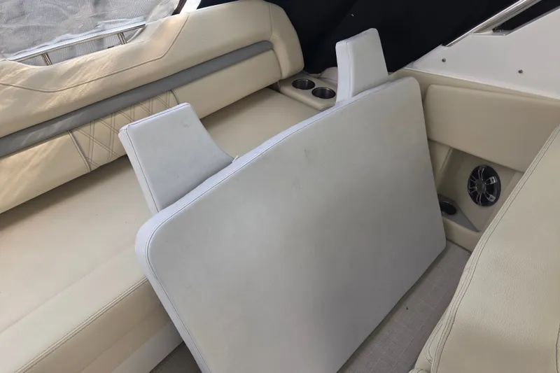 Slide: The Image of Interior seating of 2022 Regal 33 Express boat with beige upholstery and cup holders. - 31
