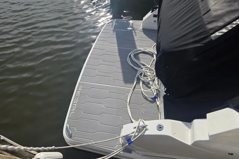 Slide: The Image of 2022 Regal 33 Express boat stern with swim platform and mooring ropes. - 28