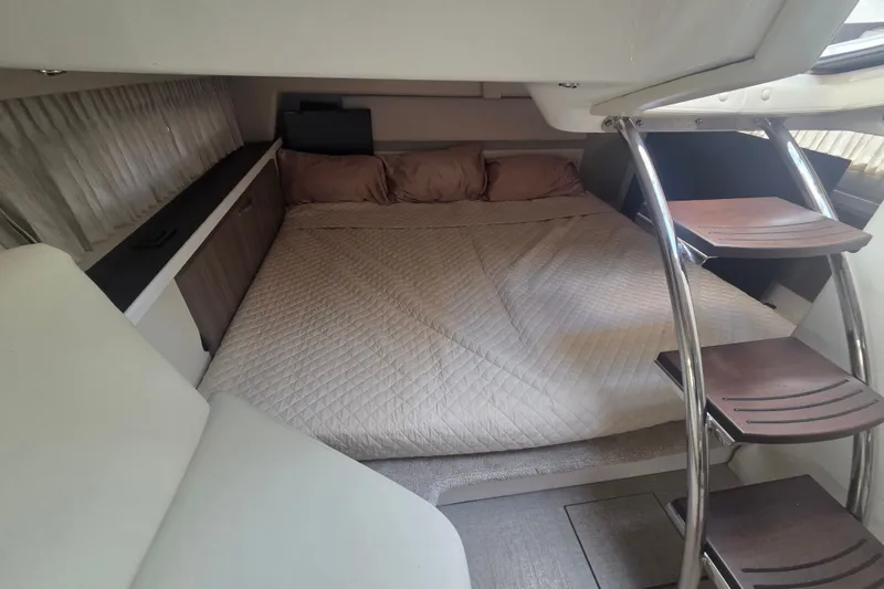 Slide: The Image of Interior cabin of 2022 Regal 33 Express yacht with cozy bed and wooden steps. - 22