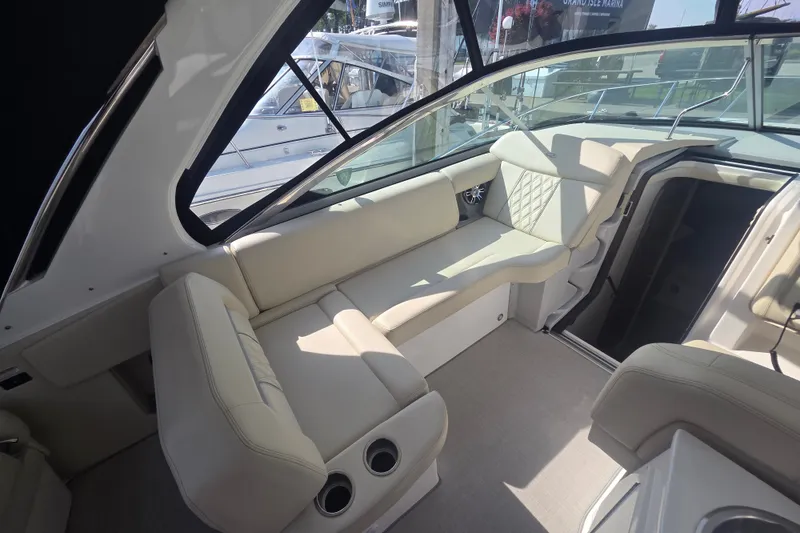 Slide: The Image of 2022 Regal 33 Express boat interior with beige seating and modern design. - 15