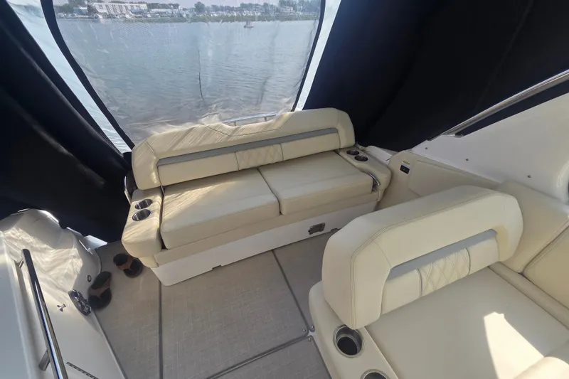Slide: The Image of Interior of 2022 Regal 33 Express boat with beige seating and cup holders. - 13