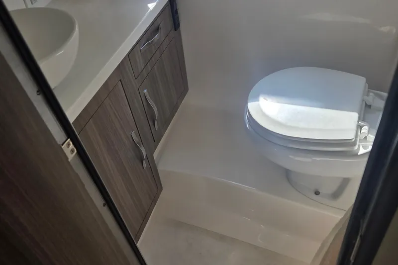 Slide: The Image of 2022 Regal 33 Express bathroom with modern fixtures and wooden cabinetry. - 27