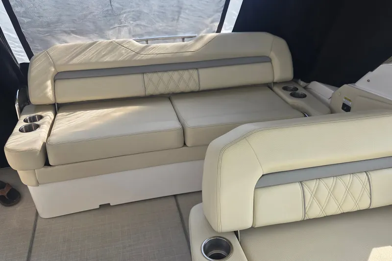 Slide: The Image of Luxurious beige seating on 2022 Regal 33 Express boat with cup holders and elegant stitching. - 14