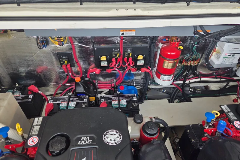 Slide: The Image of Engine compartment of a 2022 Regal 33 Express boat, showcasing batteries and wiring. - 36