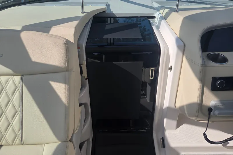 Slide: The Image of Interior view of 2022 Regal 33 Express boat, featuring beige leather seating and modern controls. - 20