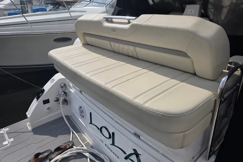 Slide: The Image of 2022 Regal 33 Express boat with beige seating and deck details. - 17