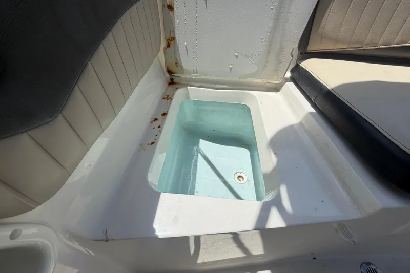 Slide: The Image of Interior of a 2018 Stingray 204 LR boat showing seating and storage compartment. - 53