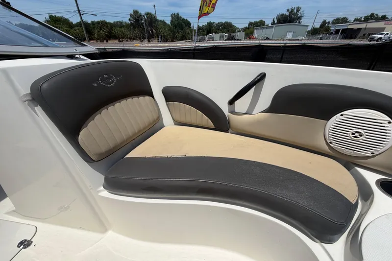 Slide: The Image of 2018 Stingray 204 LR boat interior with cushioned seating and speaker. - 36