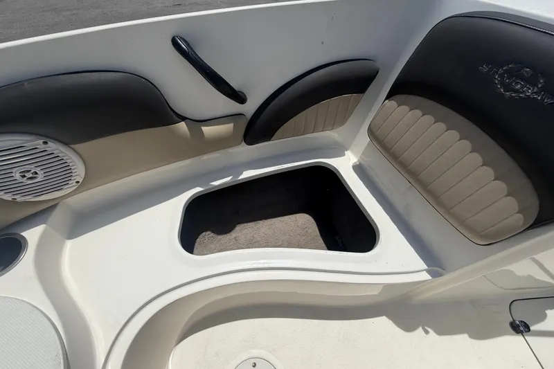 Slide: The Image of Interior of a 2018 Stingray 204 LR boat showing seating and storage compartment. - 31