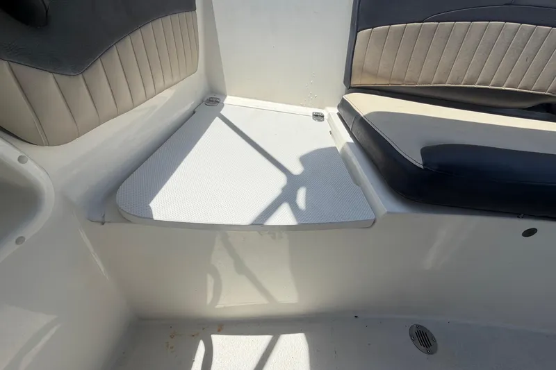 Slide: The Image of Interior seating of a 2018 Stingray 204 LR boat, featuring cushioned seats and a step. - 52