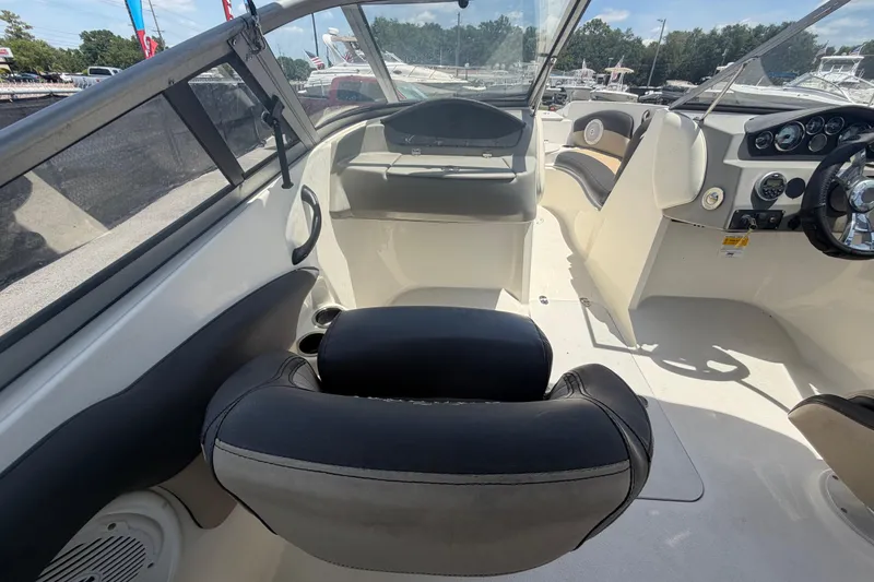 Slide: The Image of Interior view of a 2018 Stingray 204 LR boat, featuring seating and dashboard controls. - 21