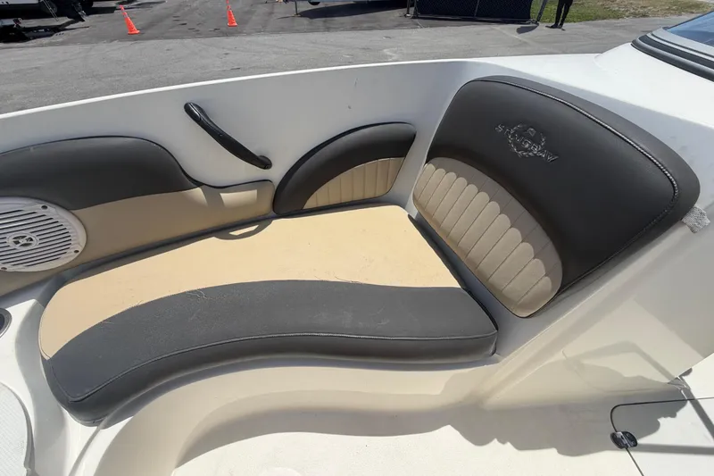 Slide: The Image of 2018 Stingray 204 LR boat interior with cushioned seating and speaker. - 30