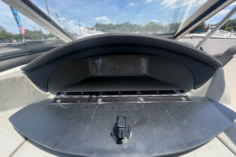 Slide: The Image of Open glove compartment of a 2018 Stingray 204 LR boat under a clear blue sky. - 25