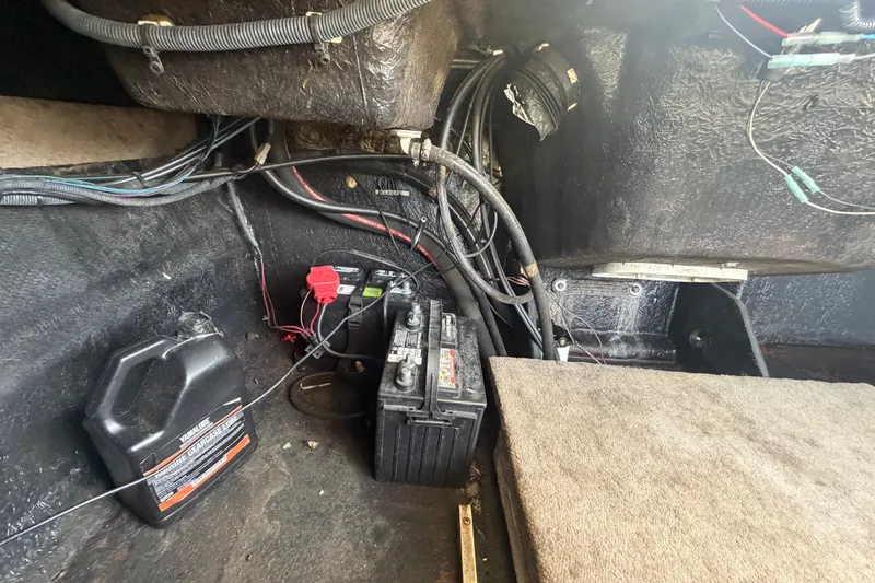 Slide: The Image of 2018 Stingray 204 LR boat interior showing battery and wiring setup. - 51