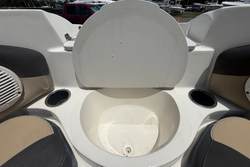Slide: The Image of 2018 Stingray 204 LR boat interior with cup holders and seating area. - 33