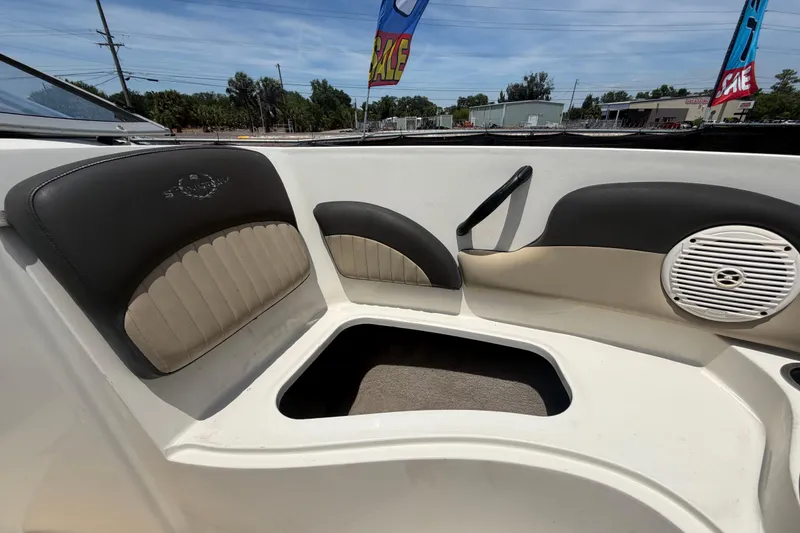 Slide: The Image of Interior seating of a 2018 Stingray 204 LR boat with speaker and storage. - 37