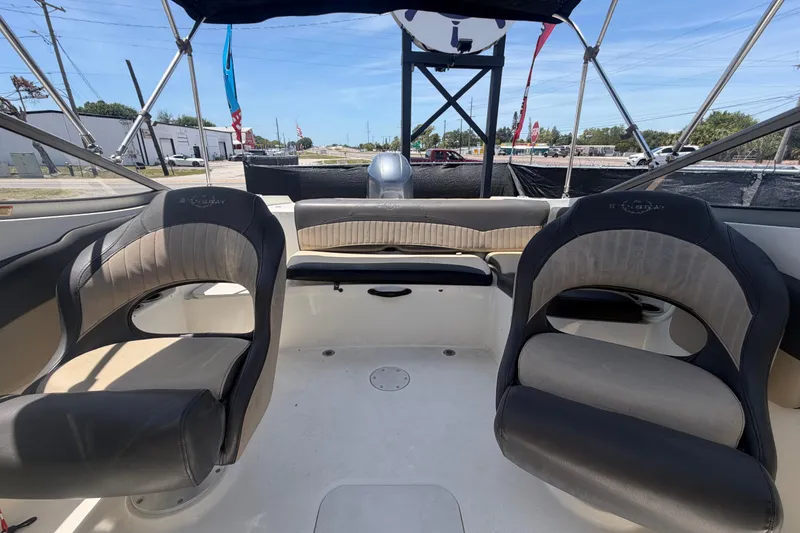Slide: The Image of Interior of a 2018 Stingray 204 LR boat with seating and canopy. - 44