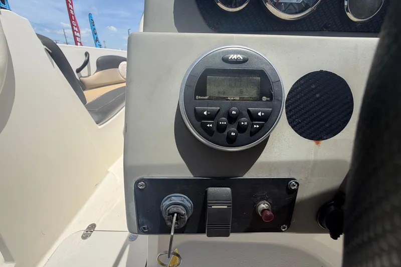 Slide: The Image of Control panel of a 2018 Stingray 204 LR boat with audio system and ignition. - 19