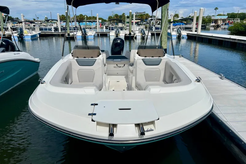 Slide: The Image of 2026 Hurricane SunDeck Sport 2050 OB boat docked at marina, featuring spacious seating. - 4