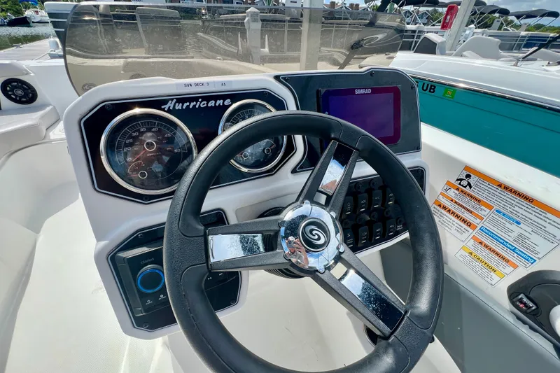 Slide: The Image of 2026 Hurricane SunDeck Sport 2050 OB boat dashboard with steering wheel and gauges. - 7
