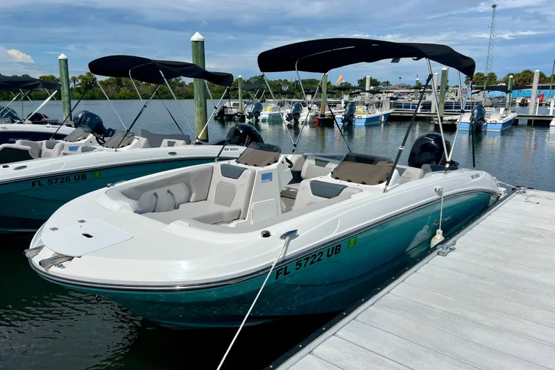 Slide: The Image of 2026 Hurricane SunDeck Sport 2050 OB boat docked at marina with bimini top. - 3