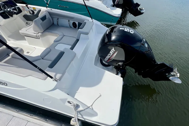 Slide: The Image of 2026 Hurricane SunDeck Sport 2050 OB boat with Mercury outboard motor on calm water. - 5