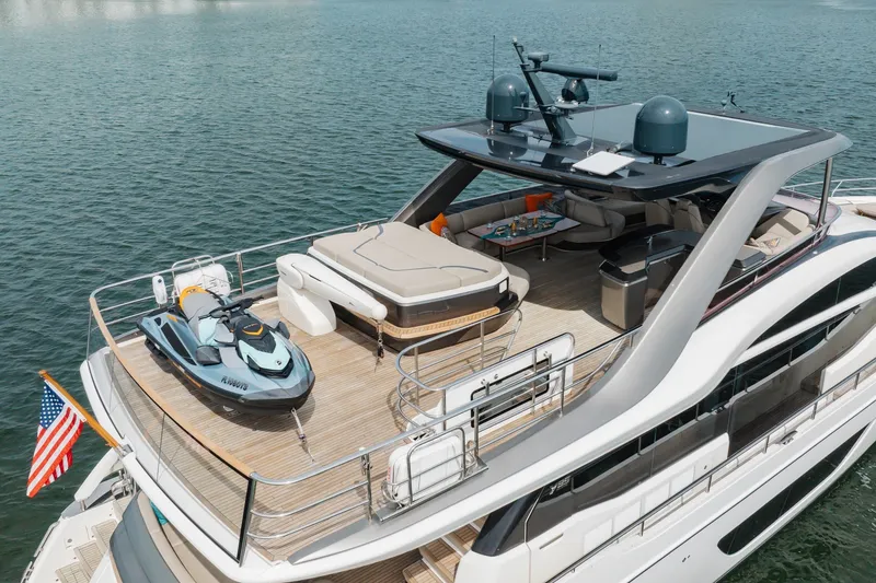 Slide: The Image of Luxurious 2021 Princess Y85 yacht with spacious deck and jet ski, cruising on serene waters. - 54