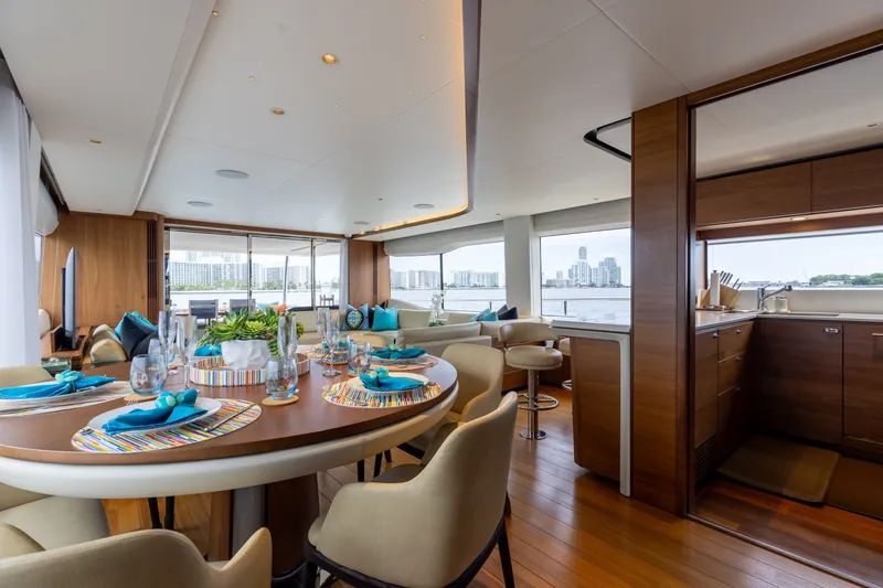 Slide: The Image of Luxurious interior of 2021 Princess Y85 yacht with elegant dining setup and cityscape view. - 32