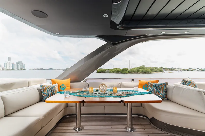 Slide: The Image of Luxurious 2021 Princess Y85 yacht interior with elegant seating and scenic waterfront view. - 57