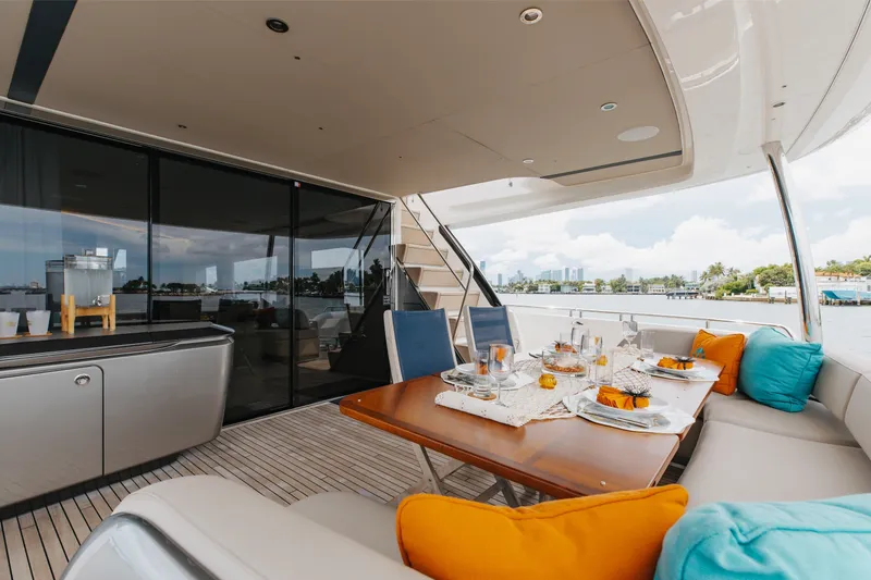Slide: The Image of Luxurious 2021 Princess Y85 yacht deck with elegant dining setup and vibrant cushions. - 23