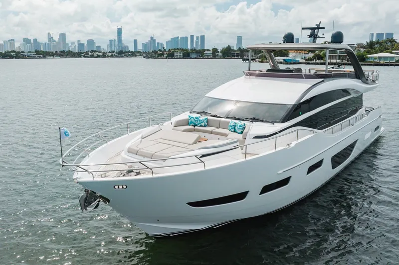 Slide: The Image of Luxurious 2021 Princess Y85 yacht cruising near a city skyline on a sunny day. - 13