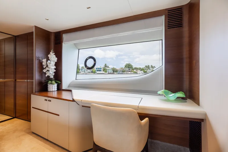 Slide: The Image of Luxurious interior of 2021 Princess Y85 yacht with elegant desk and scenic window view. - 44