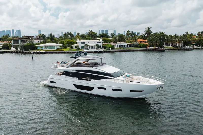 Slide: The Image of Luxurious 2021 Princess Y85 yacht cruising near waterfront homes under a cloudy sky. - 7