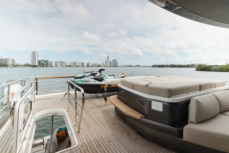 Slide: The Image of Luxurious 2021 Princess Y85 yacht deck with jet ski, overlooking city skyline and water. - 63