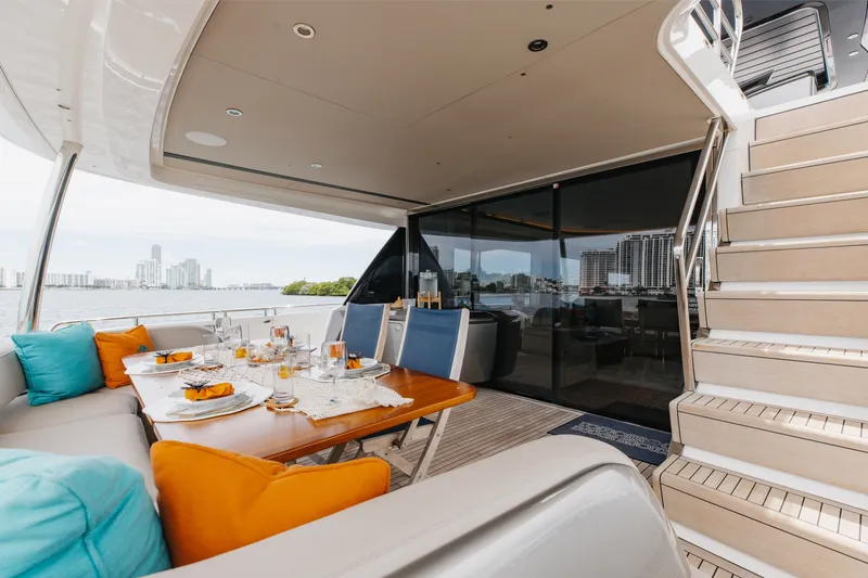 Slide: The Image of Luxurious 2021 Princess Y85 yacht deck with elegant dining setup and city skyline view. - 22