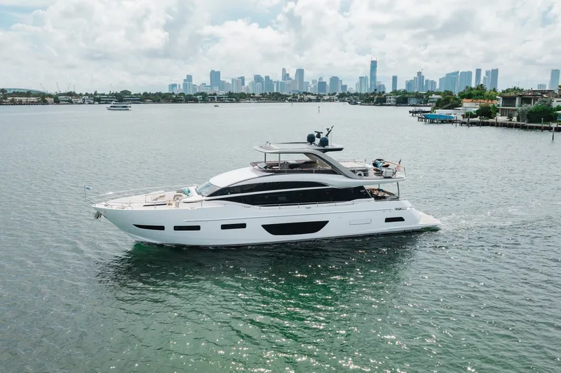 Slide: The Image of Luxurious 2021 Princess Y85 yacht cruising near a city skyline on a sunny day. - 9
