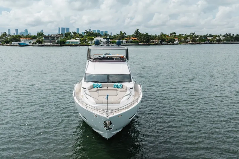 Slide: The Image of Luxurious 2021 Princess Y85 yacht on calm water with city skyline backdrop. - 12